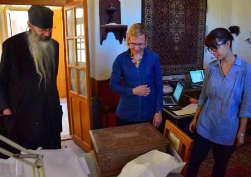 Father Justin, Monastery Librarian, Claudia Rapp, Scholarly Director, and Giulia Rossetto, Research Associate, examine the wooden box gifted to the monastery by Agnes Smith Lewis and Margaret Dunlop Gibson to house Syrus Sinaiticus.  (Syrus Sinaiticus is on permanent display in the monastery’s museum.) 